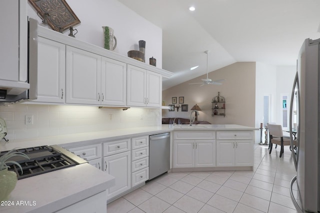 kitchen with sink, kitchen peninsula, ceiling fan, stainless steel appliances, and white cabinets