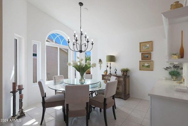 tiled dining area featuring high vaulted ceiling and a chandelier