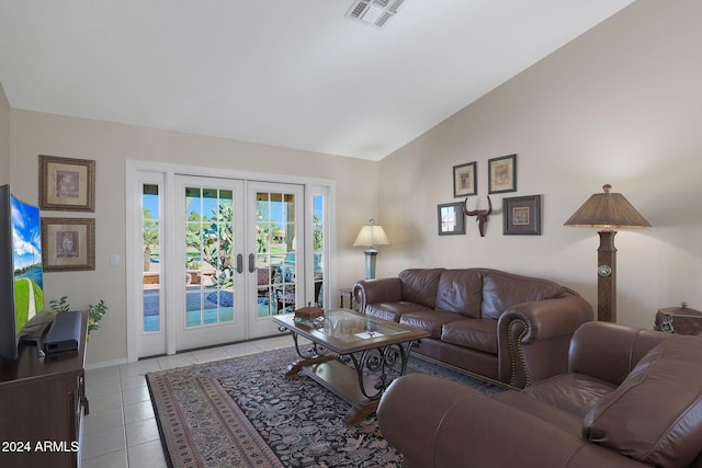 living room with french doors, high vaulted ceiling, and light tile patterned floors