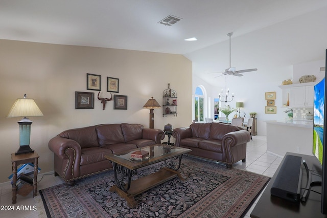 living room featuring vaulted ceiling, ceiling fan with notable chandelier, and light tile patterned floors