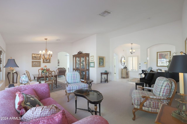 living room with an inviting chandelier, light colored carpet, and vaulted ceiling