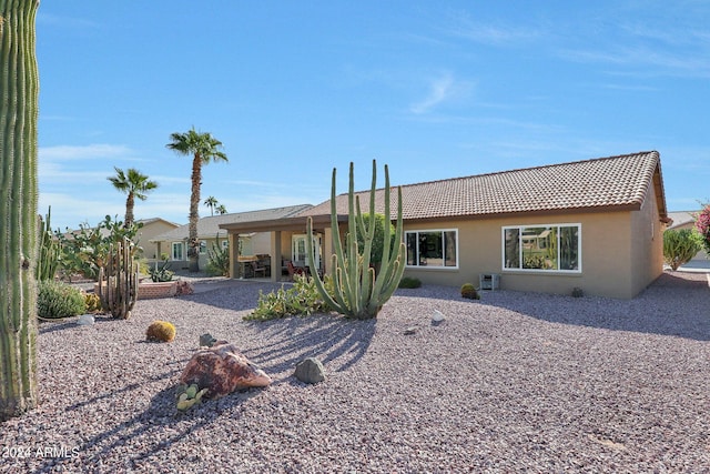 back of house with a patio and central AC