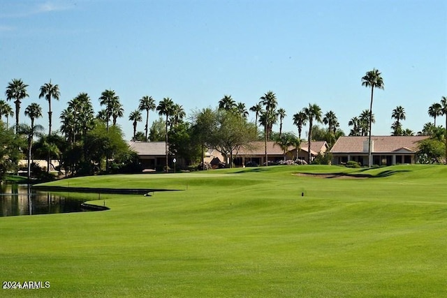 view of home's community featuring a water view and a lawn