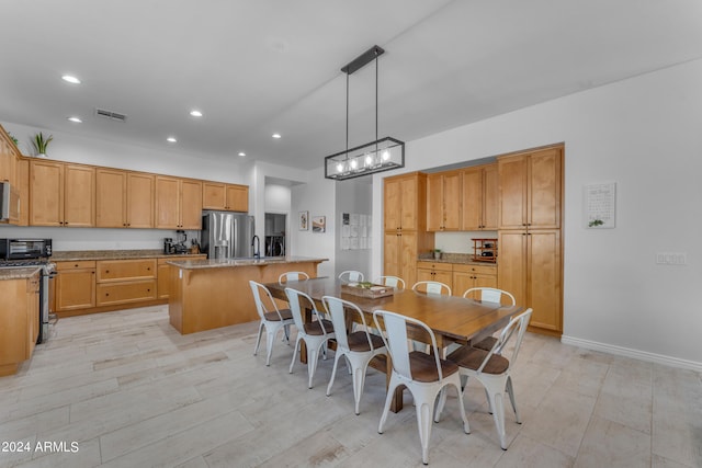 dining room with a chandelier and light hardwood / wood-style flooring