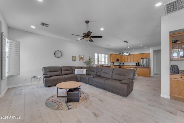 living room with ceiling fan and light wood-type flooring