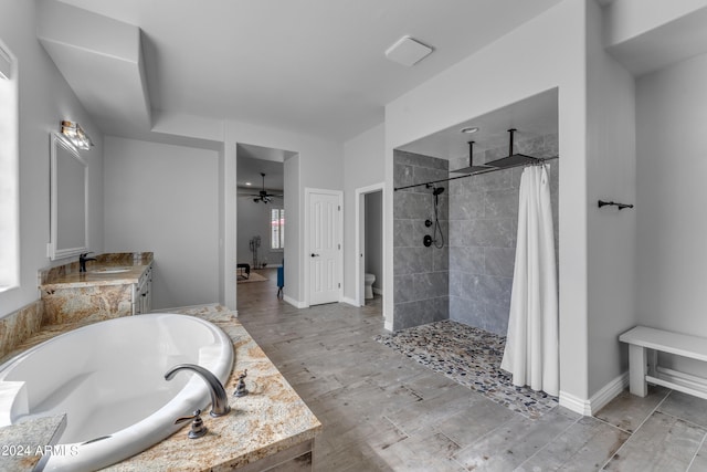 full bathroom featuring ceiling fan, vanity, separate shower and tub, wood-type flooring, and toilet