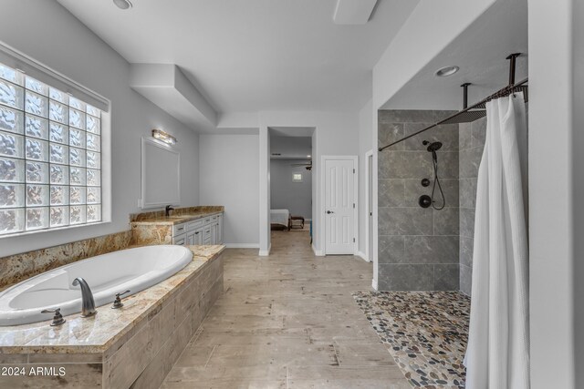 bathroom featuring vanity, shower with separate bathtub, and hardwood / wood-style floors