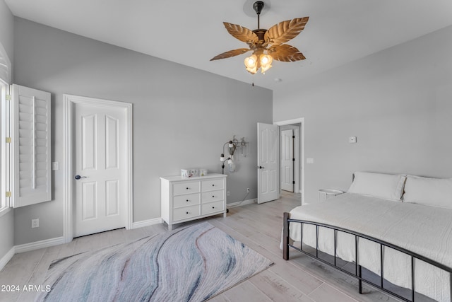 bedroom with ceiling fan and light hardwood / wood-style floors