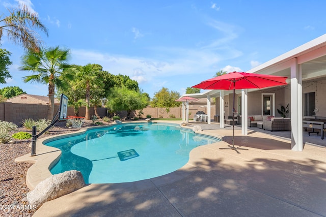 view of swimming pool featuring outdoor lounge area, a diving board, and a patio