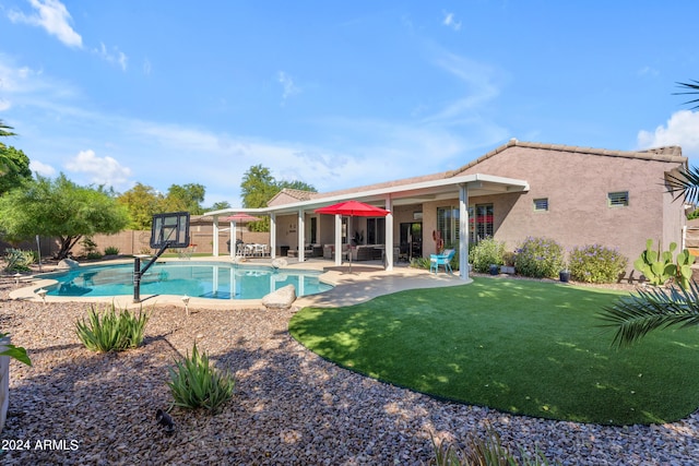 view of pool featuring a lawn and a patio area