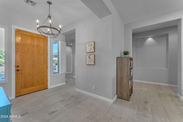 entrance foyer featuring an inviting chandelier and light hardwood / wood-style floors