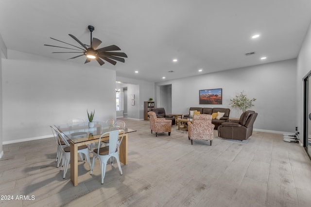 living room with ceiling fan and light hardwood / wood-style flooring