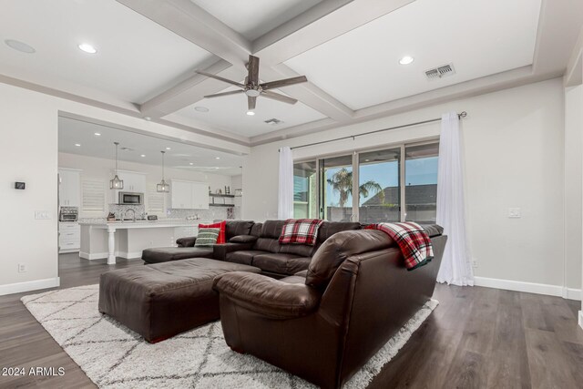 living room with beam ceiling, ceiling fan, dark hardwood / wood-style flooring, and coffered ceiling