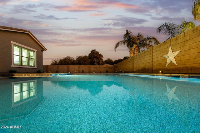 view of pool at dusk