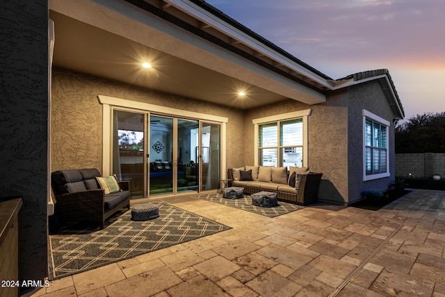 patio terrace at dusk with an outdoor living space