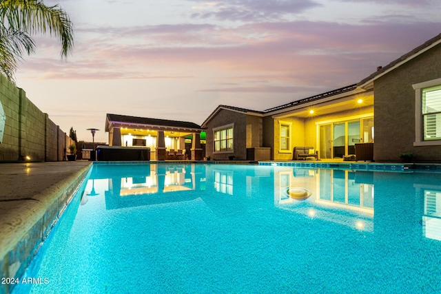 view of pool at dusk