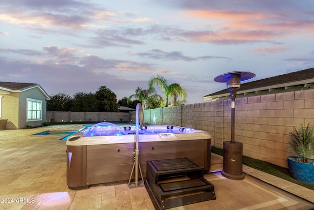 patio terrace at dusk with a hot tub