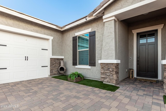 doorway to property featuring a garage