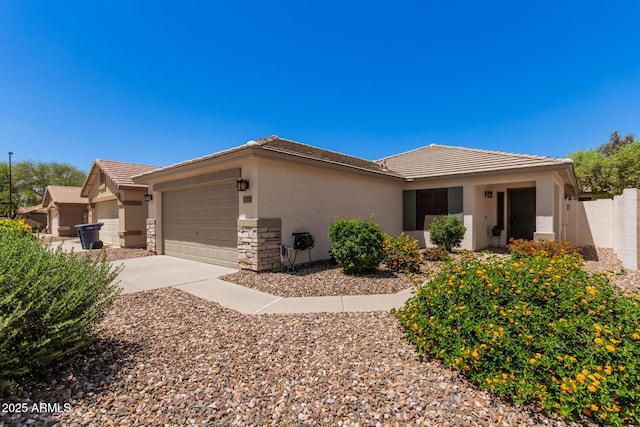 4262 E Sundance Ave, Gilbert, AZ 85297 - view of front of home featuring a garage, stone siding, stucco siding, a tiled roof, and driveway