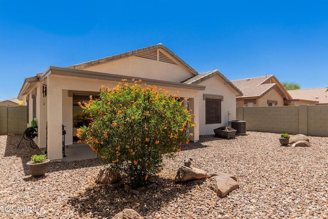 4262 E Sundance Ave, Gilbert, AZ 85297 - exterior space with a fenced backyard, stucco siding, a tiled roof, and central AC unit