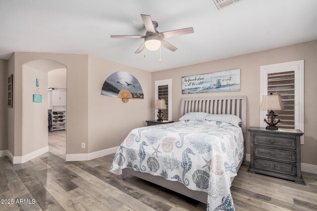 4262 E Sundance Ave, Gilbert, AZ 85297 - bedroom featuring baseboards, arched walkways, wood finished floors, and visible vents