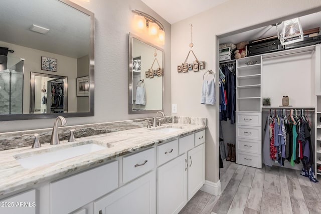 4262 E Sundance Ave, Gilbert, AZ 85297 - full bath with a sink, double vanity, wood finished floors, and a spacious closet