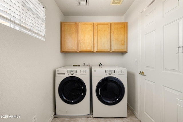3025 E Fremont Rd, Phoenix, AZ 85042 - washroom featuring cabinet space, washing machine and clothes dryer, and light tile patterned floors