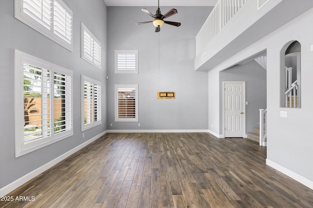 3025 E Fremont Rd, Phoenix, AZ 85042 - unfurnished living room with a towering ceiling, a ceiling fan, dark wood finished floors, and stairway