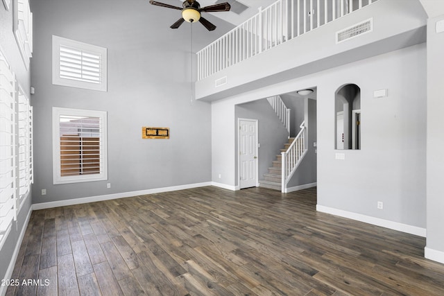 3025 E Fremont Rd, Phoenix, AZ 85042 - unfurnished living room with a high ceiling, a ceiling fan, dark wood-type flooring, and stairway