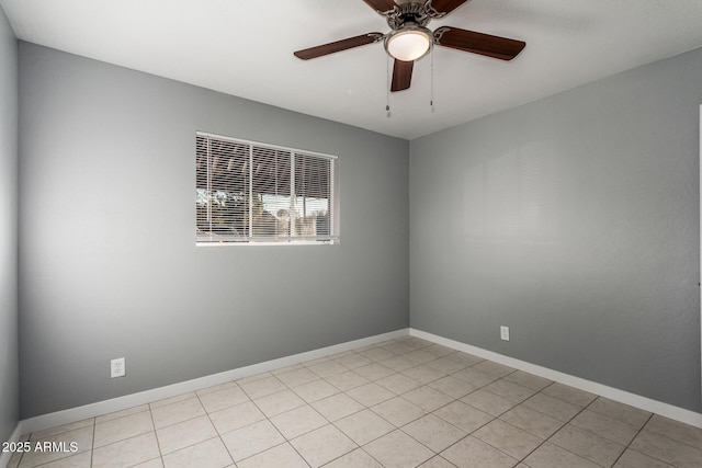 tiled empty room featuring ceiling fan