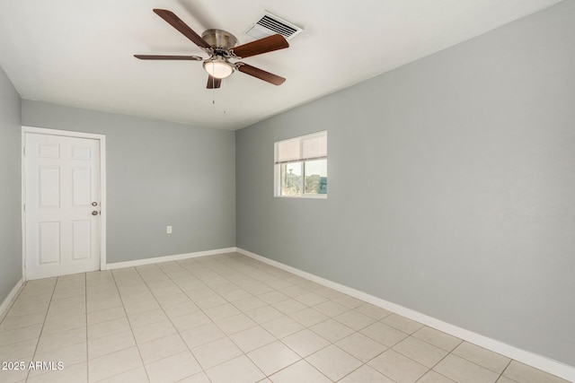 spare room featuring ceiling fan and light tile patterned floors