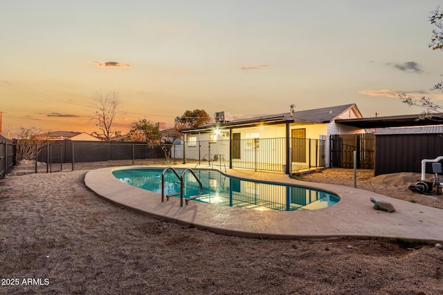 view of pool at dusk