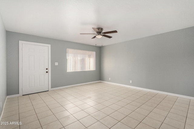 empty room with light tile patterned floors and ceiling fan