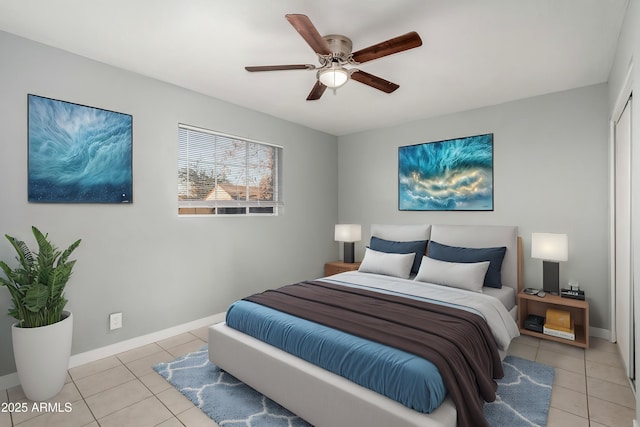 tiled bedroom featuring a closet and ceiling fan