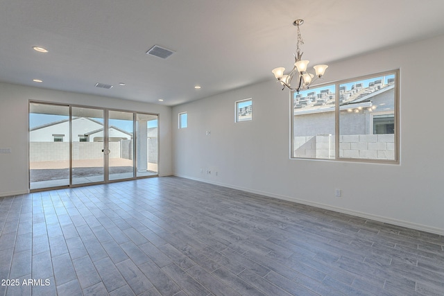 empty room featuring an inviting chandelier