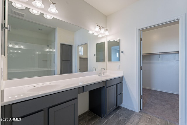 bathroom featuring walk in shower and vanity