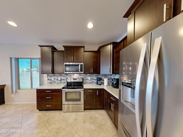 17547 W Gambit Trl, Surprise, AZ 85387 - kitchen with appliances with stainless steel finishes, decorative backsplash, dark brown cabinetry, light tile patterned floors, and recessed lighting
