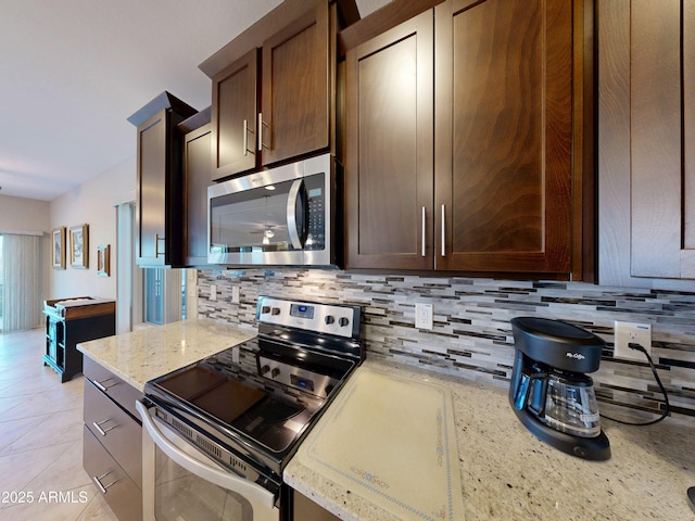 17547 W Gambit Trl, Surprise, AZ 85387 - kitchen with stainless steel appliances, tasteful backsplash, and light stone countertops