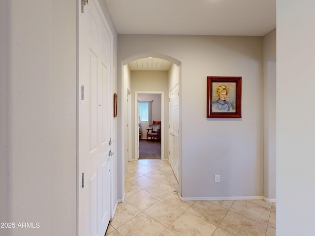 17547 W Gambit Trl, Surprise, AZ 85387 - corridor featuring arched walkways, light tile patterned floors, and baseboards