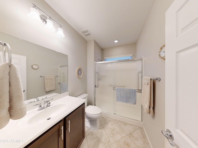 17547 W Gambit Trl, Surprise, AZ 85387 - bathroom featuring toilet, vanity, a stall shower, tile patterned flooring, and baseboards