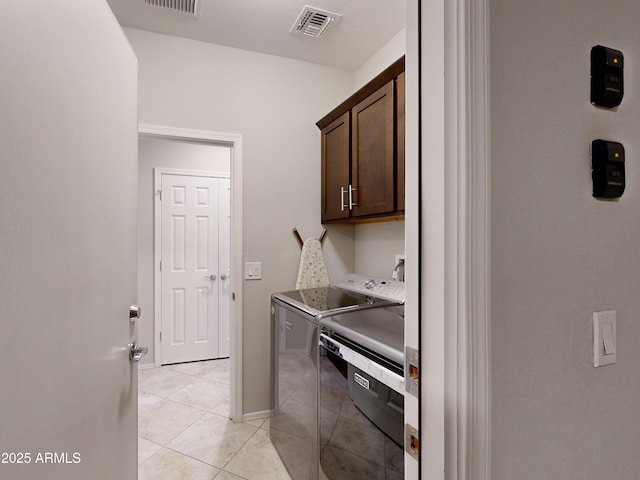17547 W Gambit Trl, Surprise, AZ 85387 - washroom featuring cabinet space, washer and clothes dryer, light tile patterned floors, and baseboards