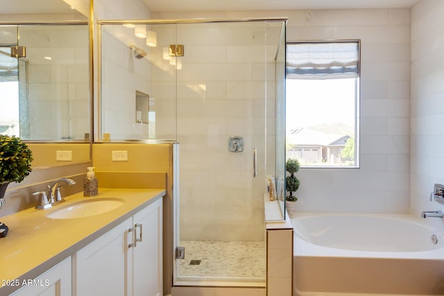 bathroom featuring vanity, a shower stall, and a bath