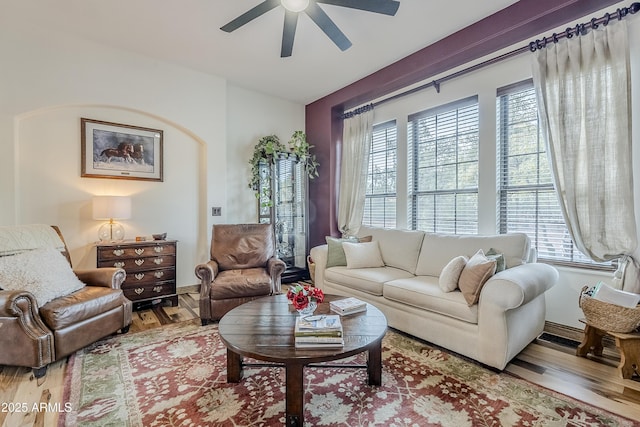 living area featuring wood finished floors and a ceiling fan