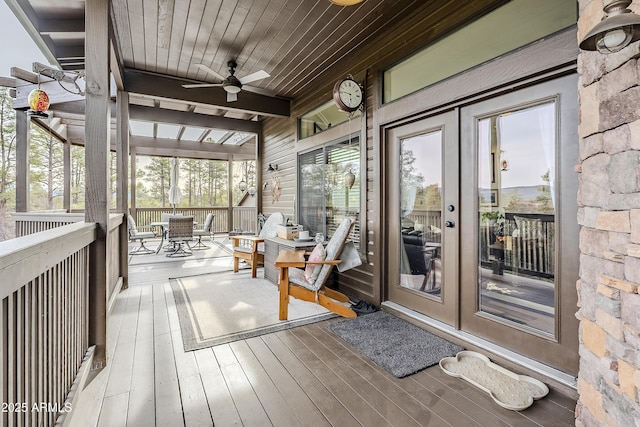 wooden deck featuring a ceiling fan and outdoor dining space