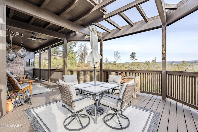 wooden terrace with ceiling fan, outdoor dining space, and a pergola