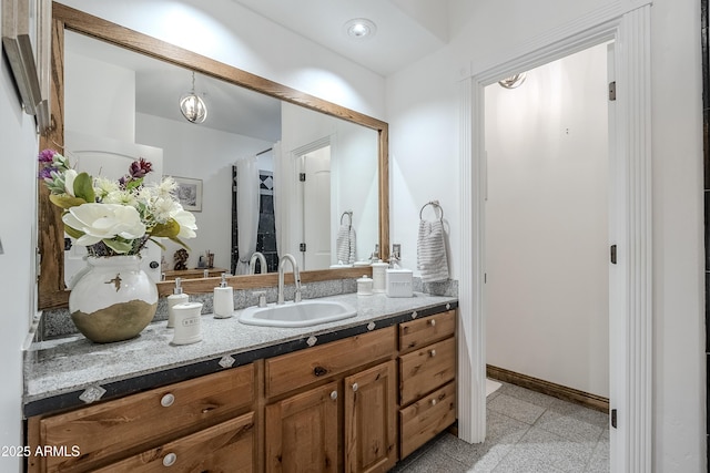 bathroom featuring vanity and baseboards