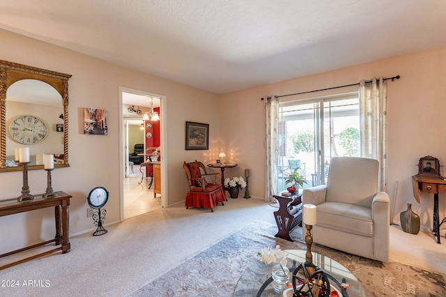 living room with a textured ceiling and light colored carpet