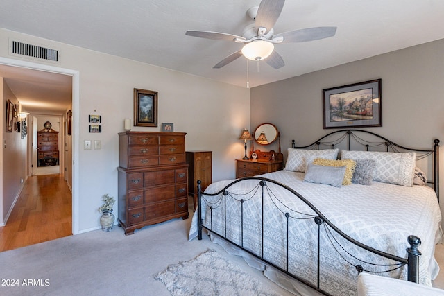 bedroom with ceiling fan and light hardwood / wood-style floors