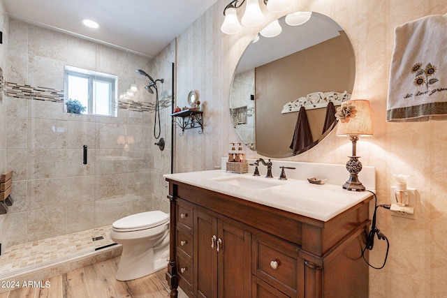 bathroom featuring vanity, toilet, hardwood / wood-style floors, and a shower with door