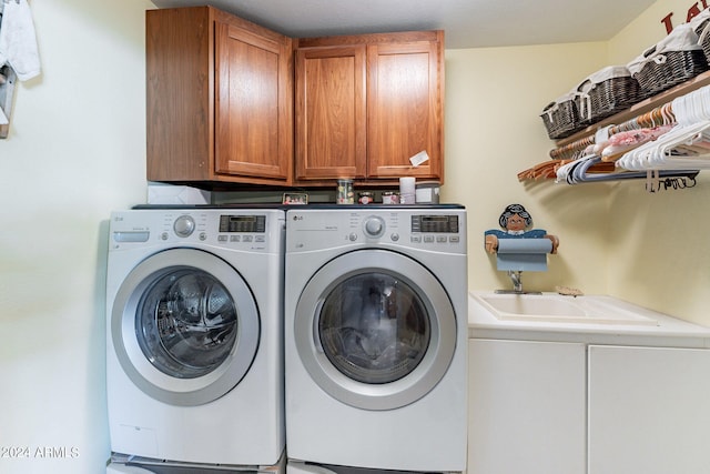 laundry room with cabinets and washer and dryer